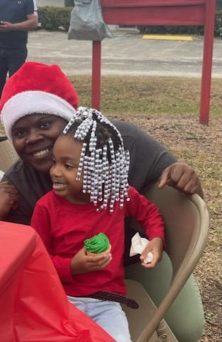 people and child at christmas park event 