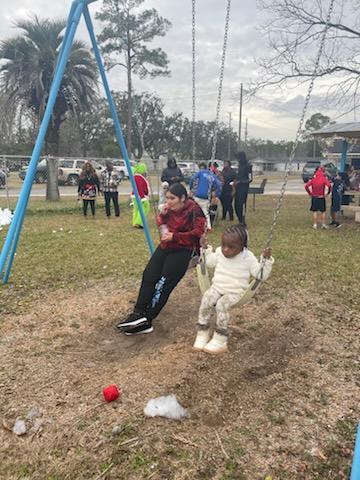 two children playing on swingset 