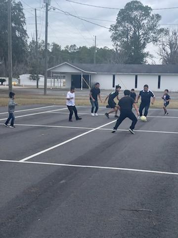 group of kids playing soccer