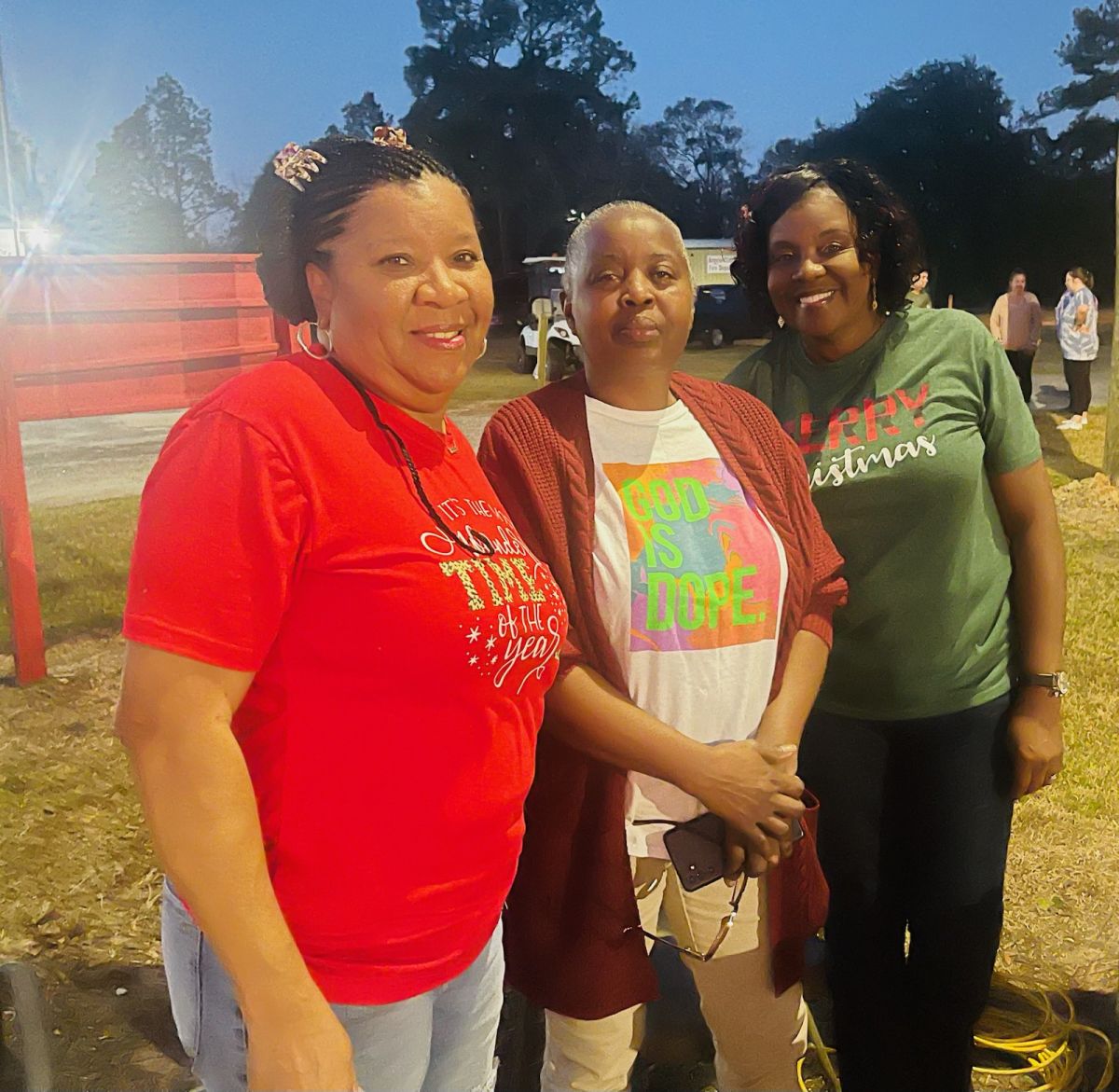 three people at park christmas event