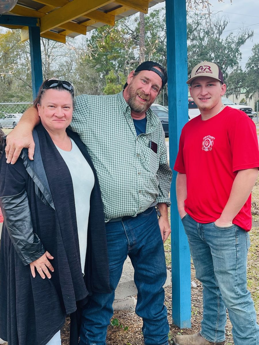 three people at park christmas event