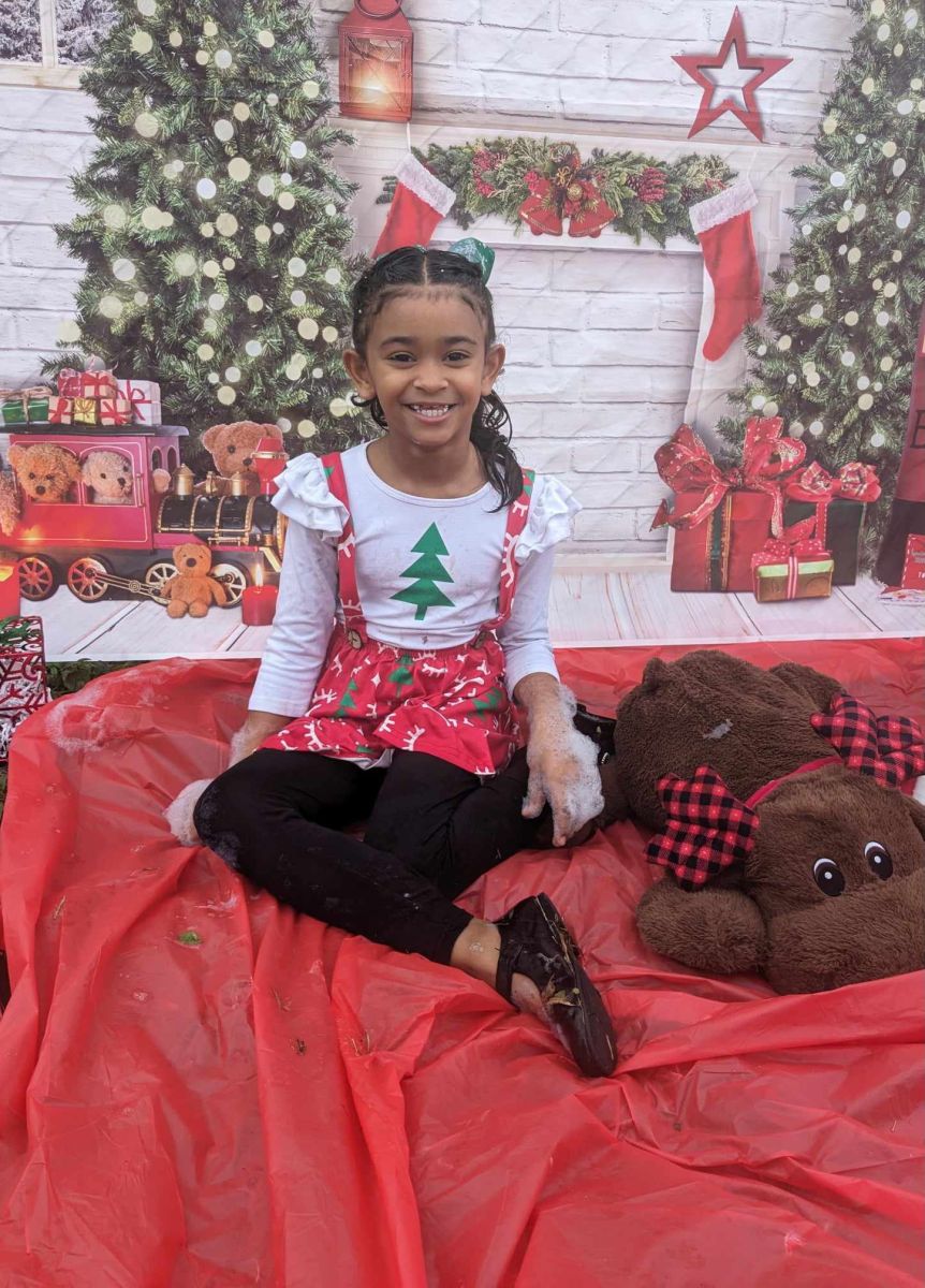 child playing by christmas trees